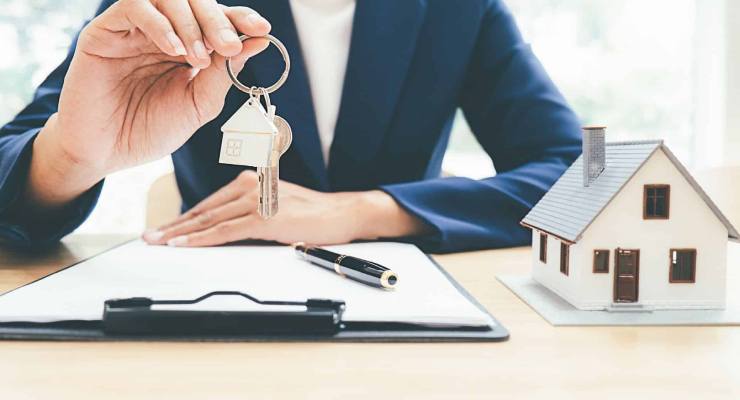 A real estate agent holds the key to the property